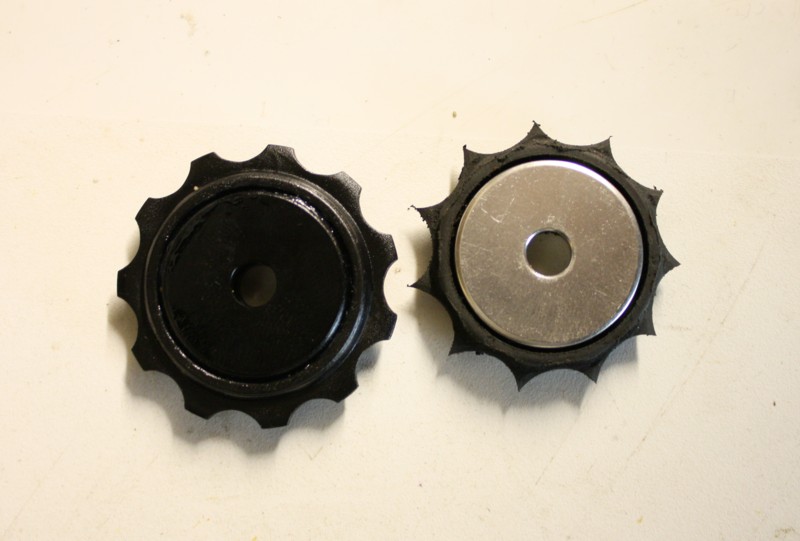 A worn jockey wheel shown alongside a new one. There's really nothing left of the old one.